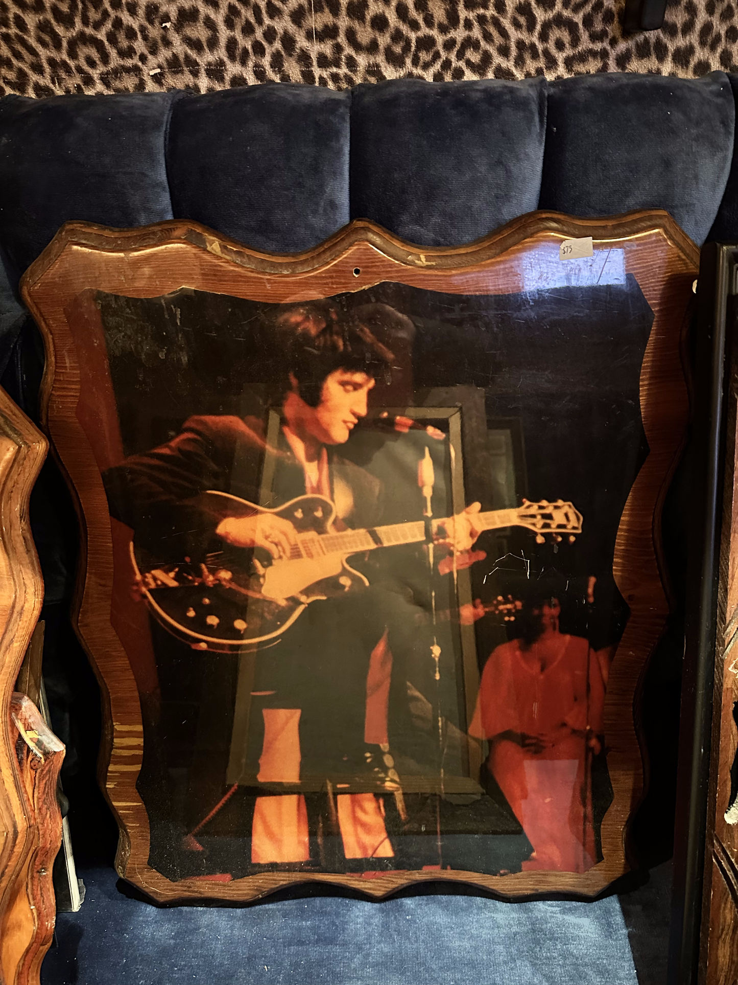 Elvis on stage playing guitar on Wood