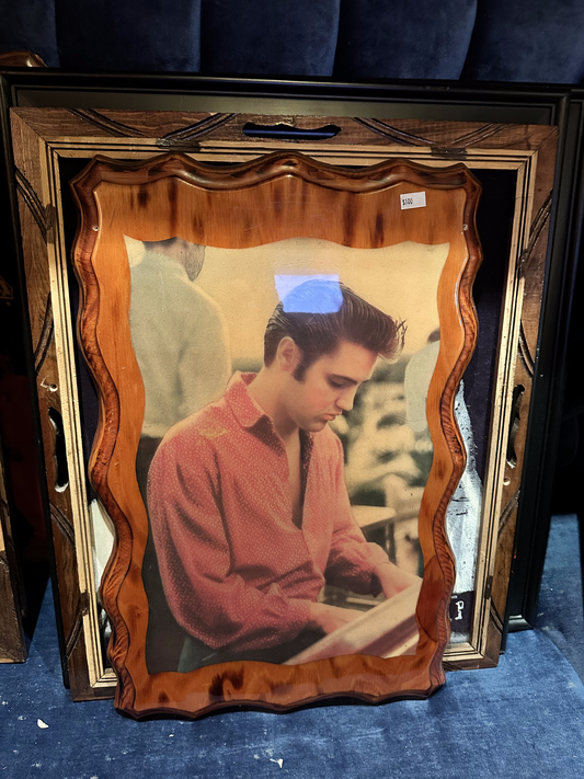 Elvis in red shirt playing the piano on Wood