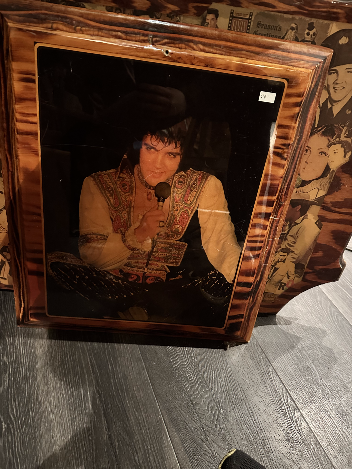 Elvis with a microphone in an ornate outfit on Wood